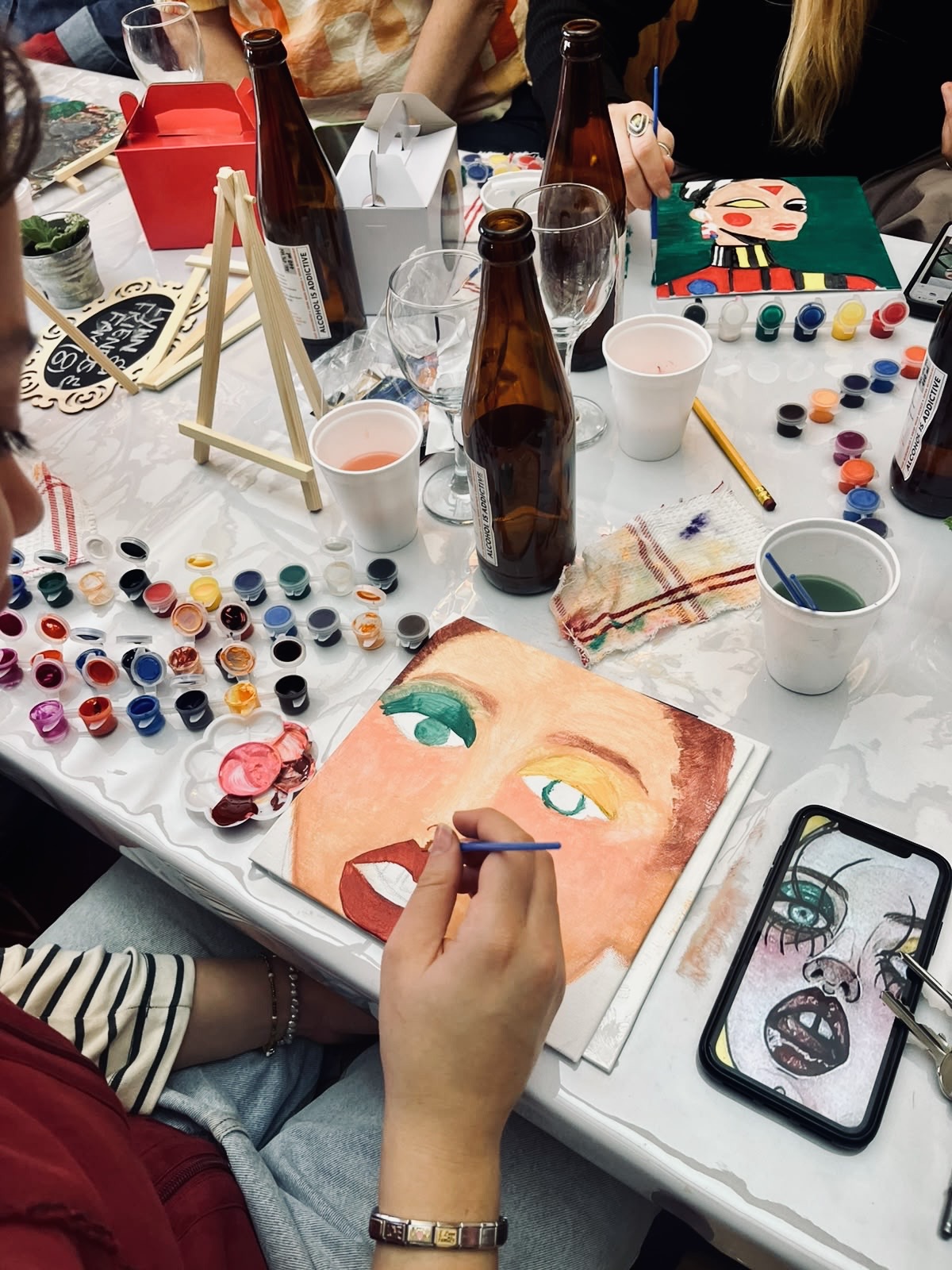 Guests painting at a Sip n Paint afternoon hosted at Hotel De Rust, De Rust, Klein Karoo