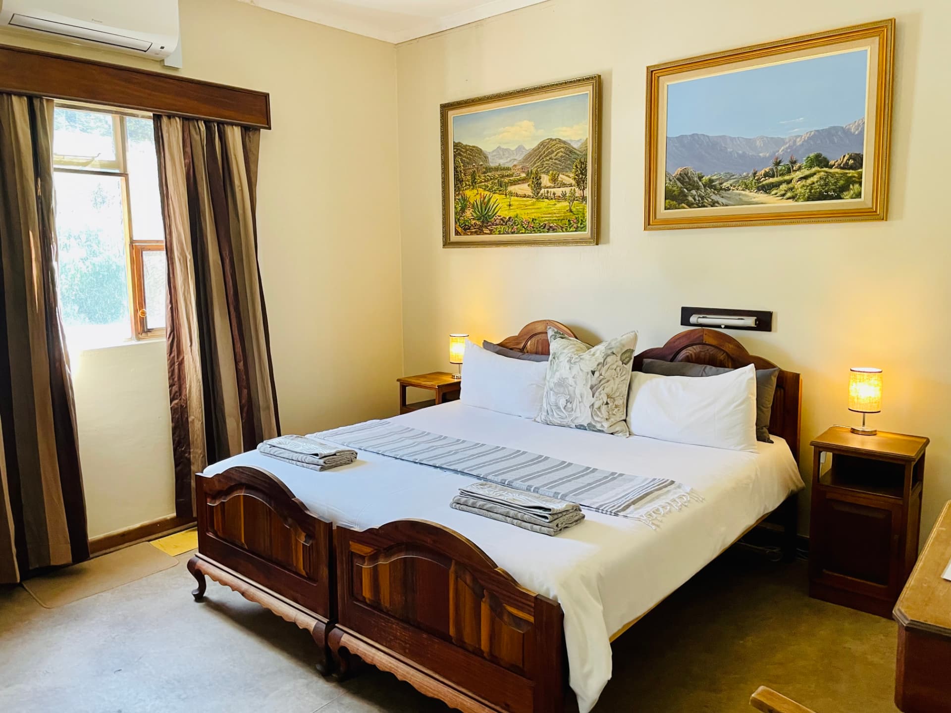 King's Quarters, a spacious king bedroom with landscape paintings at Hotel De Rust, De Rust, Klein Karoo